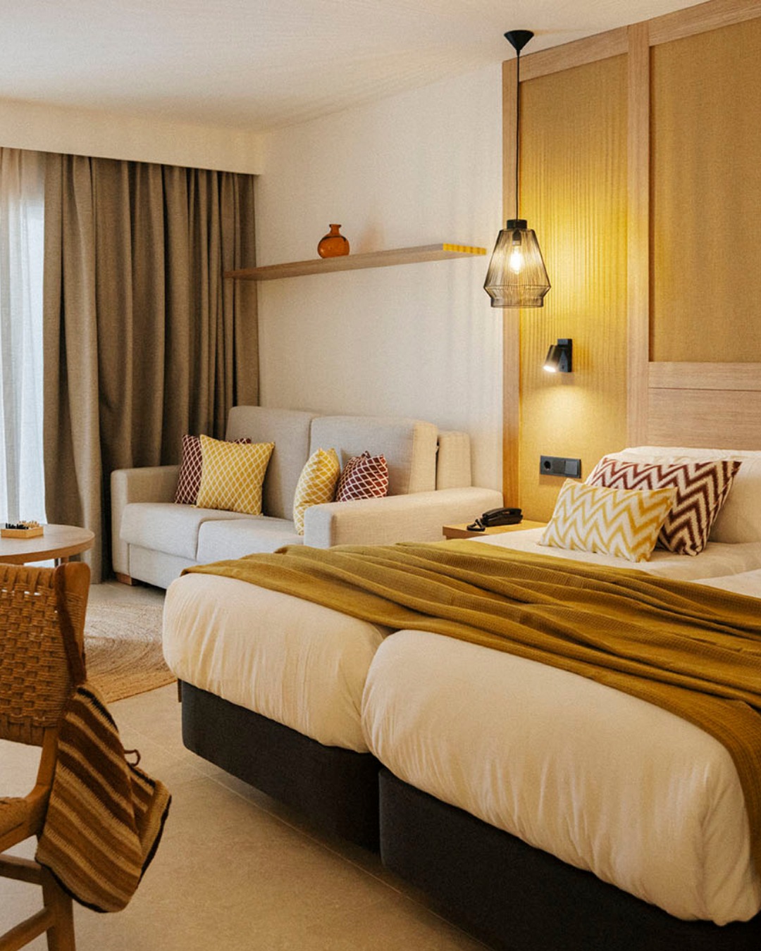 La calidez no viene solo de la luz. Se construye con capas. Textiles que suavizan el espacio.Colores que envuelven sin pesar. Tejidos pensados para acompañar el descanso y hacer que la habitación resulte acogedora desde el primer momento.Nada está ahí para llamar la atención. Todo está para que el espacio se sienta amable, equilibrada y fácil de habitar.